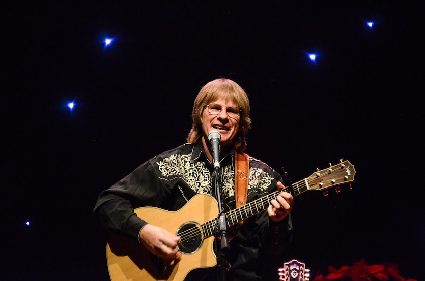 Photo of Chris Collins playing guitar.