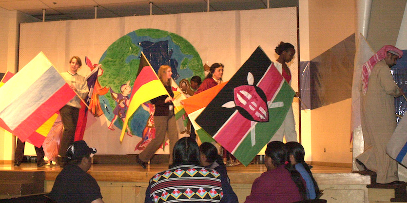 International Night photo of students with flags on stage.