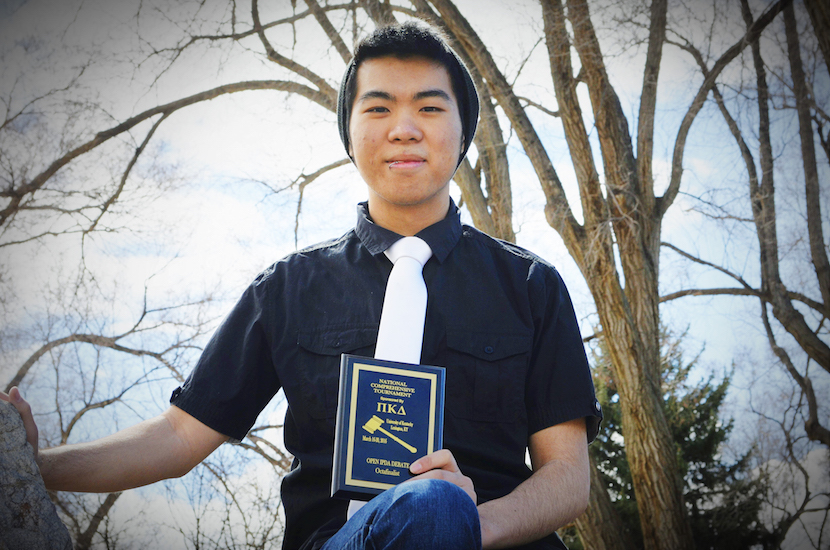 Mike Chen holding trophy. 