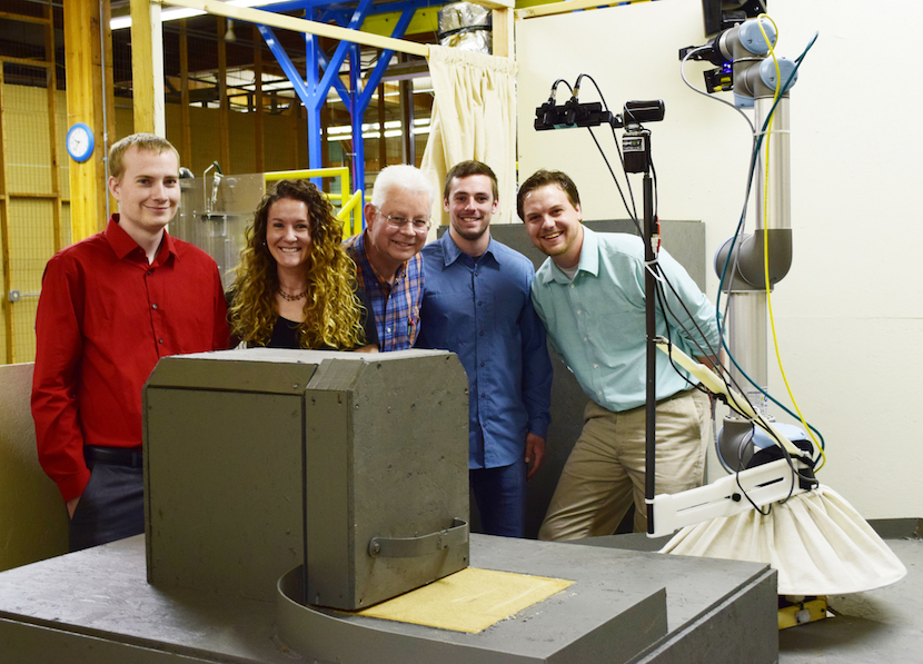 Group shot of the students working on the robot. 