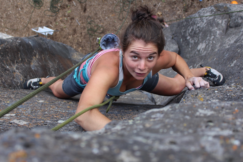 Caitlin Vitale-Sullivan climbing up steep rocks. 
