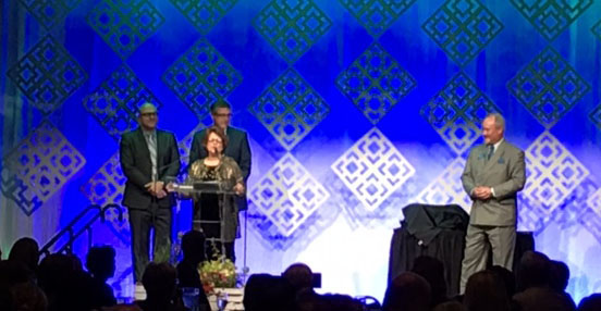 Bessie Katsilometes, retired ISU-Meridian associate vice president, accepts award. Standing directly behind her is Rex Force, ISU’s vice president for health science