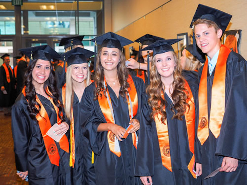 A photo of ISU Meridian graduates in their robes and hats. 