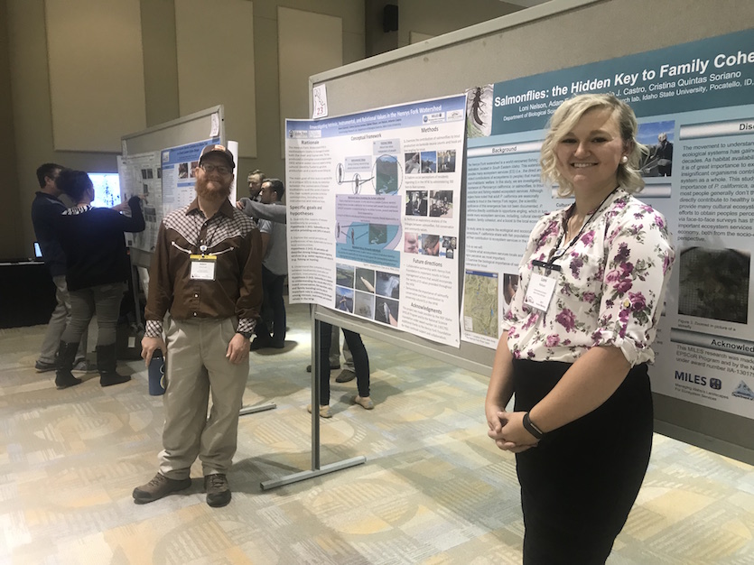 Photo of two student researchers in front of their research poster at EPSCOR meeting