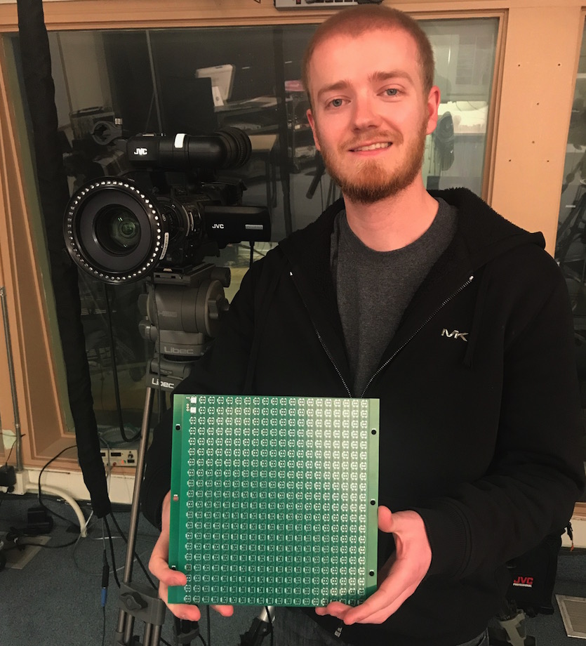 ISU robotics student Jeremy Briggs holding a waffer board.