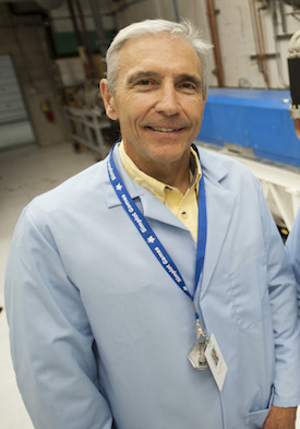 Photo of Jon Stoner in lab coat. 