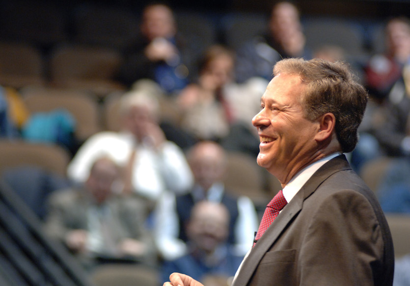 Arthur C. Vailas portrait with a crowd in background. 