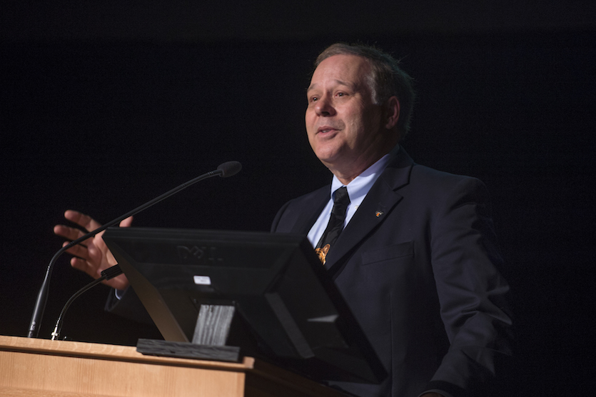 Photo of President Vailas speaking at a podium.