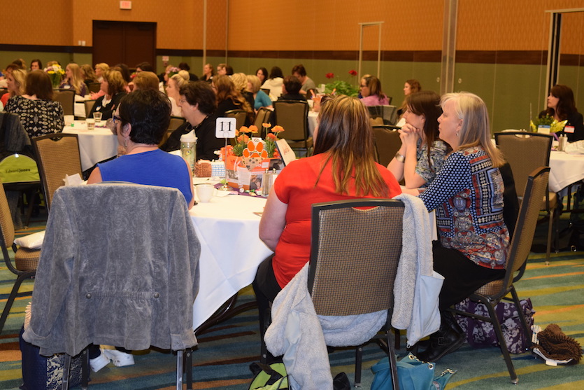 Photo of attendees at tables at last year's symposium.