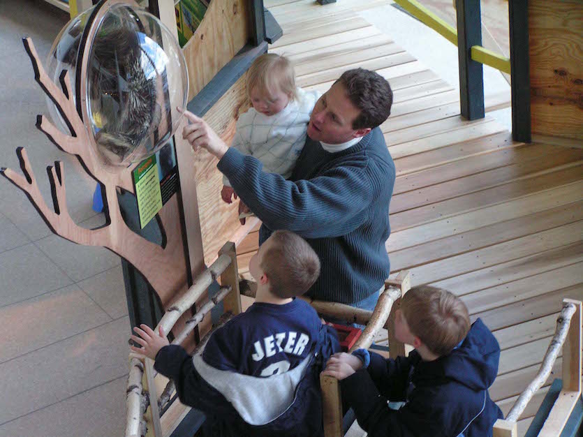 Photo of family viewing Tree Exhibit.