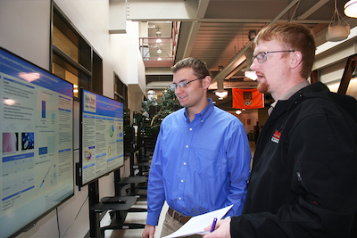 Two students with research poster