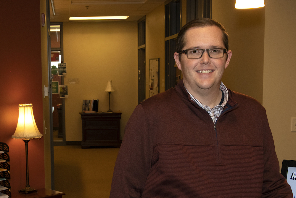 Bruce Blair standing in office.