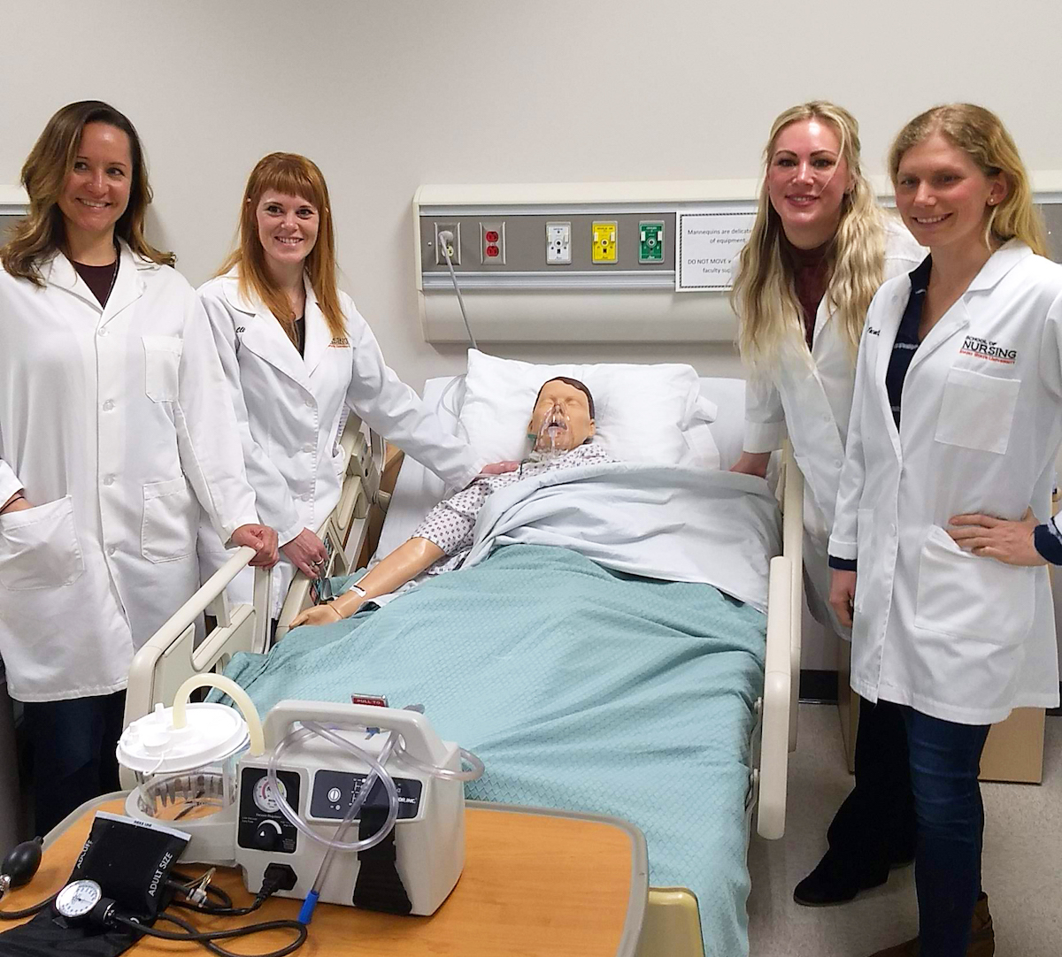 Jackson Fund scholarship recipients with a medical dummy.