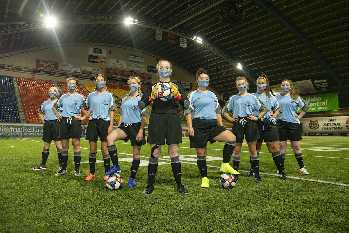 Wolves cast members in soccer uniforms on Holt Arena Field