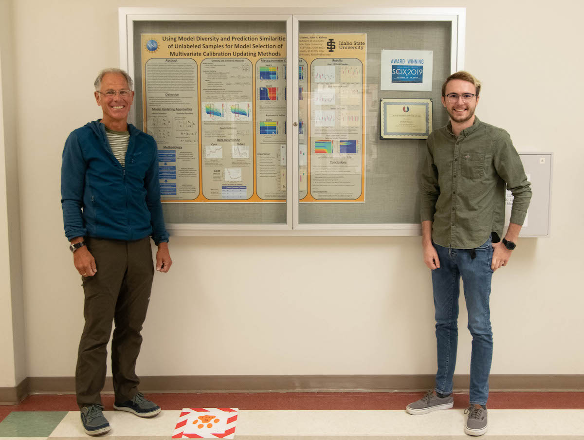 Professor John Kalivas and undergrad Robbie Spiers standing by poster Spiers presented.