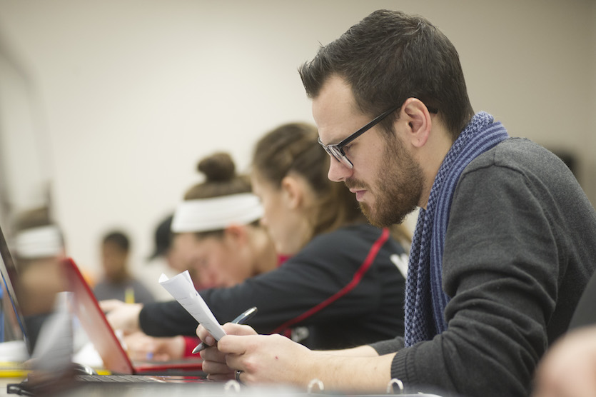 Photo of student studying with other students in the background