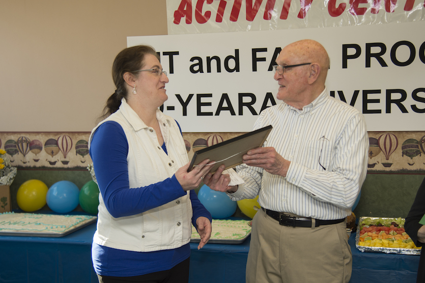 Photo of Cindy Seiger receiving recognition certificate from Payson Fugitt