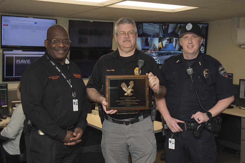 Photo of ISU Public Safety officers holding plaque.