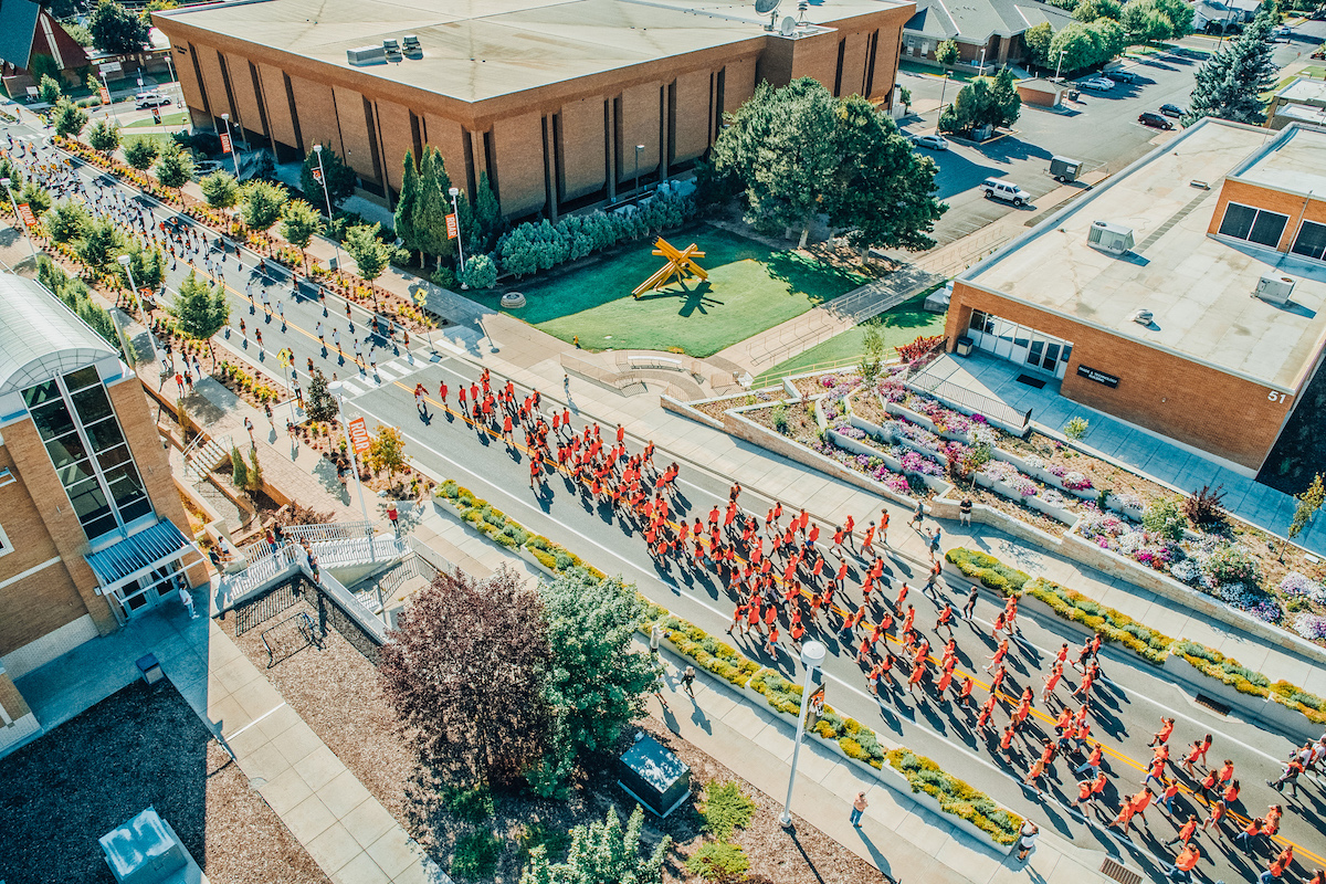 Students marching down Martin Luther King Ave. during fall 2019 March through the Arch ceremony