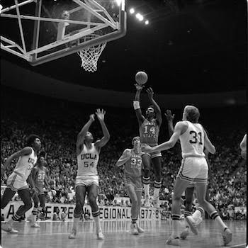 ISU player Ed Thompson taking a shot over UCLA defenders.