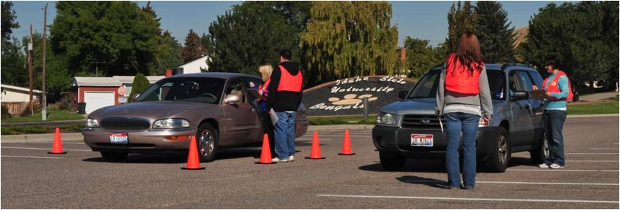 Students working with a car at a previous CarFit event