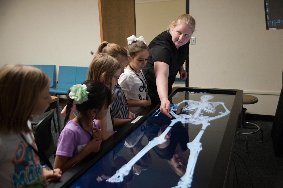 Photo of students and instructor at Anatomage Table