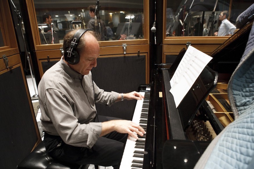 A photo of keyboardist Roistein playing a piano. 