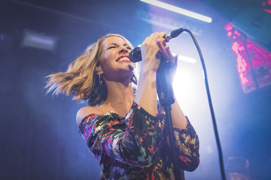 Morgan James singing with a mic in her hand.