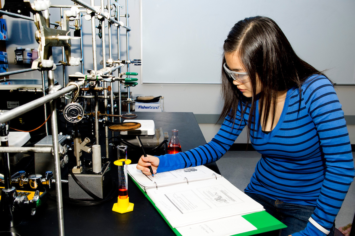 An ISU undergraduate researcher in a lab.