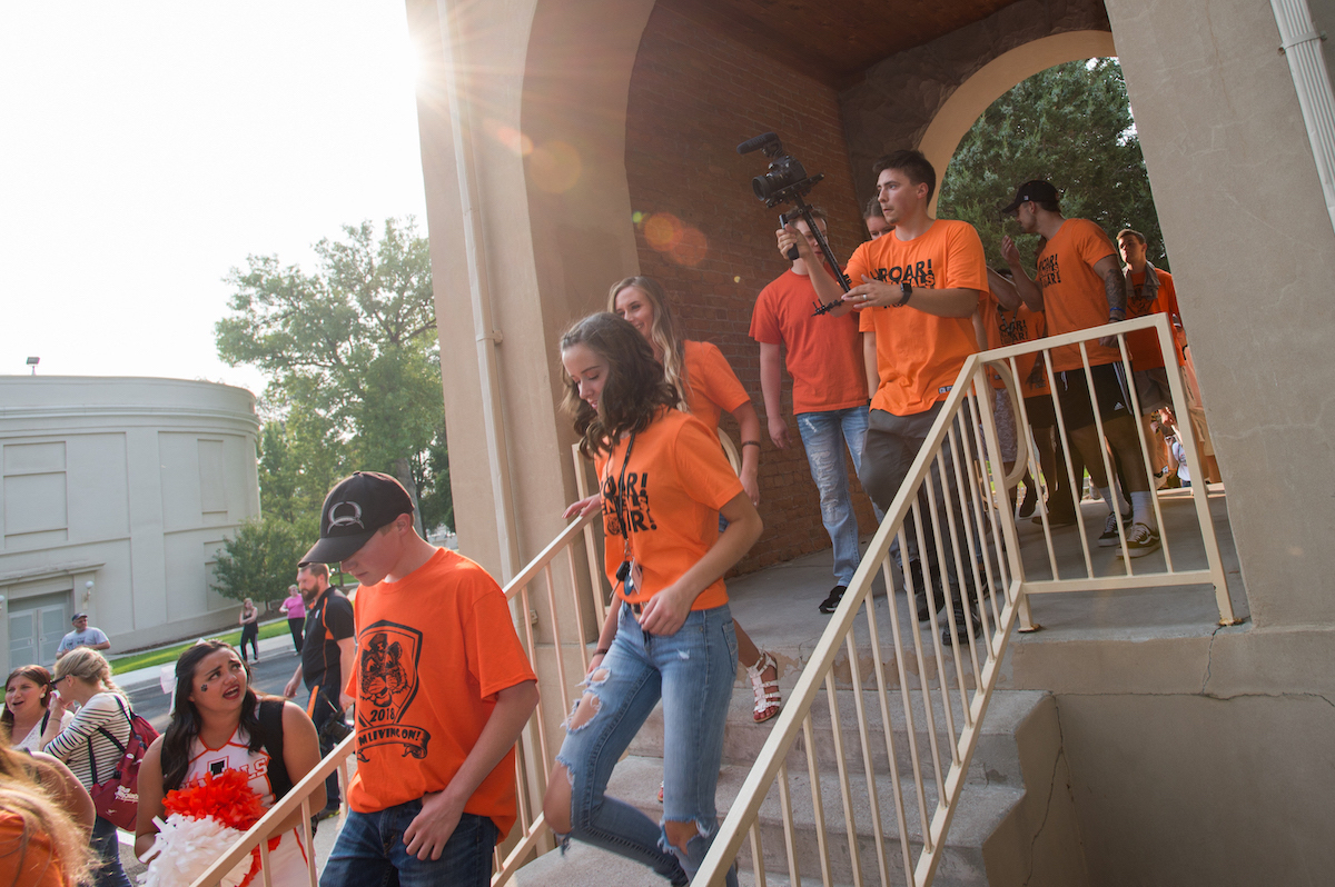 Students marching through Swanson Arch