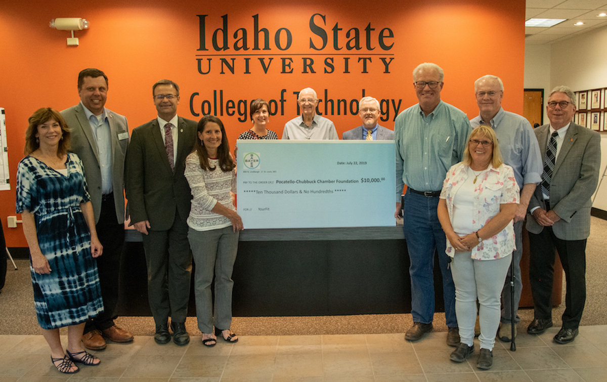 Dignitaries gathered around the big check presented.