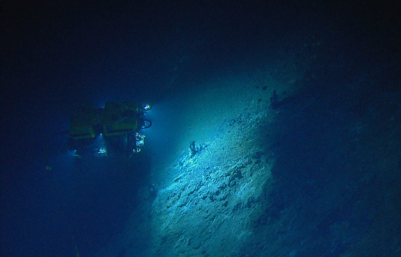 Submarine exploring ocean bottom.
