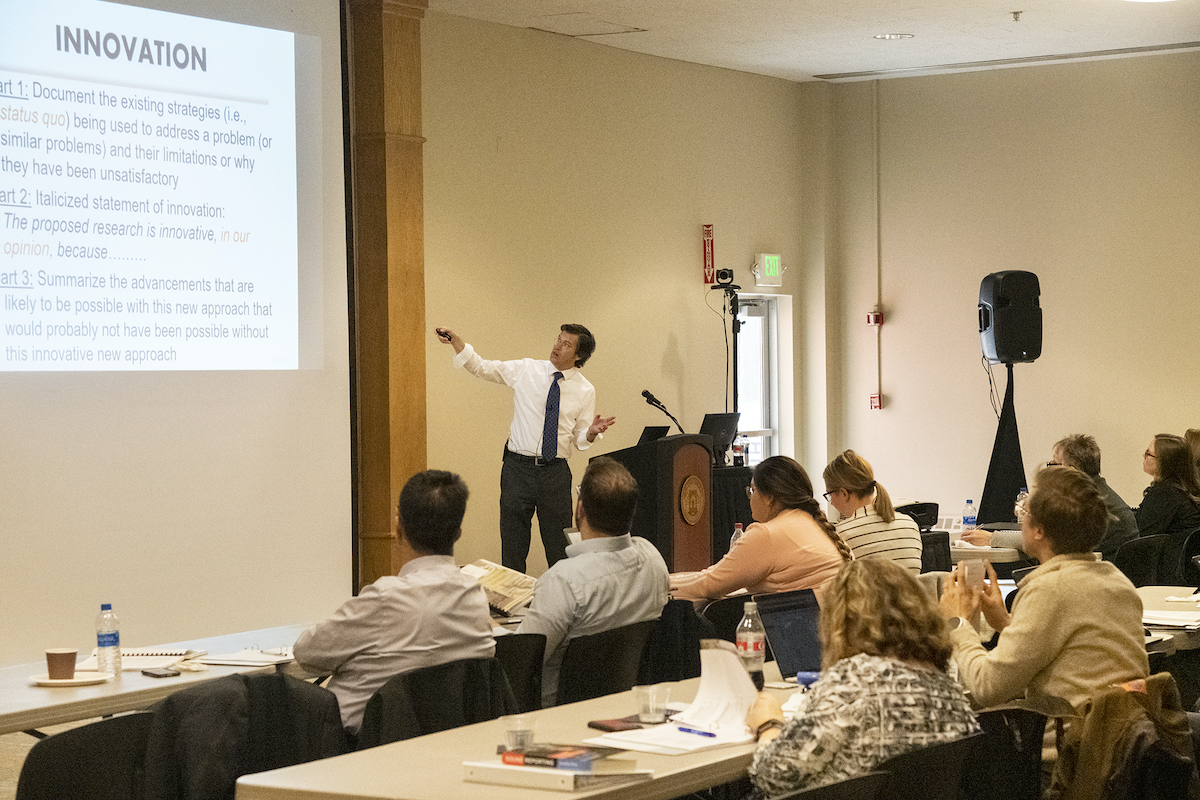 Lecturer pointing at screen at workshop 