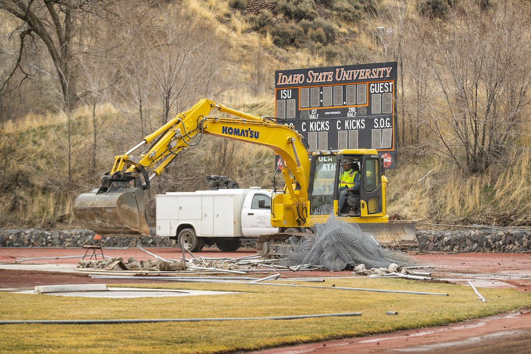 A heavy equipment operated tears down existing structure at Davis Field.