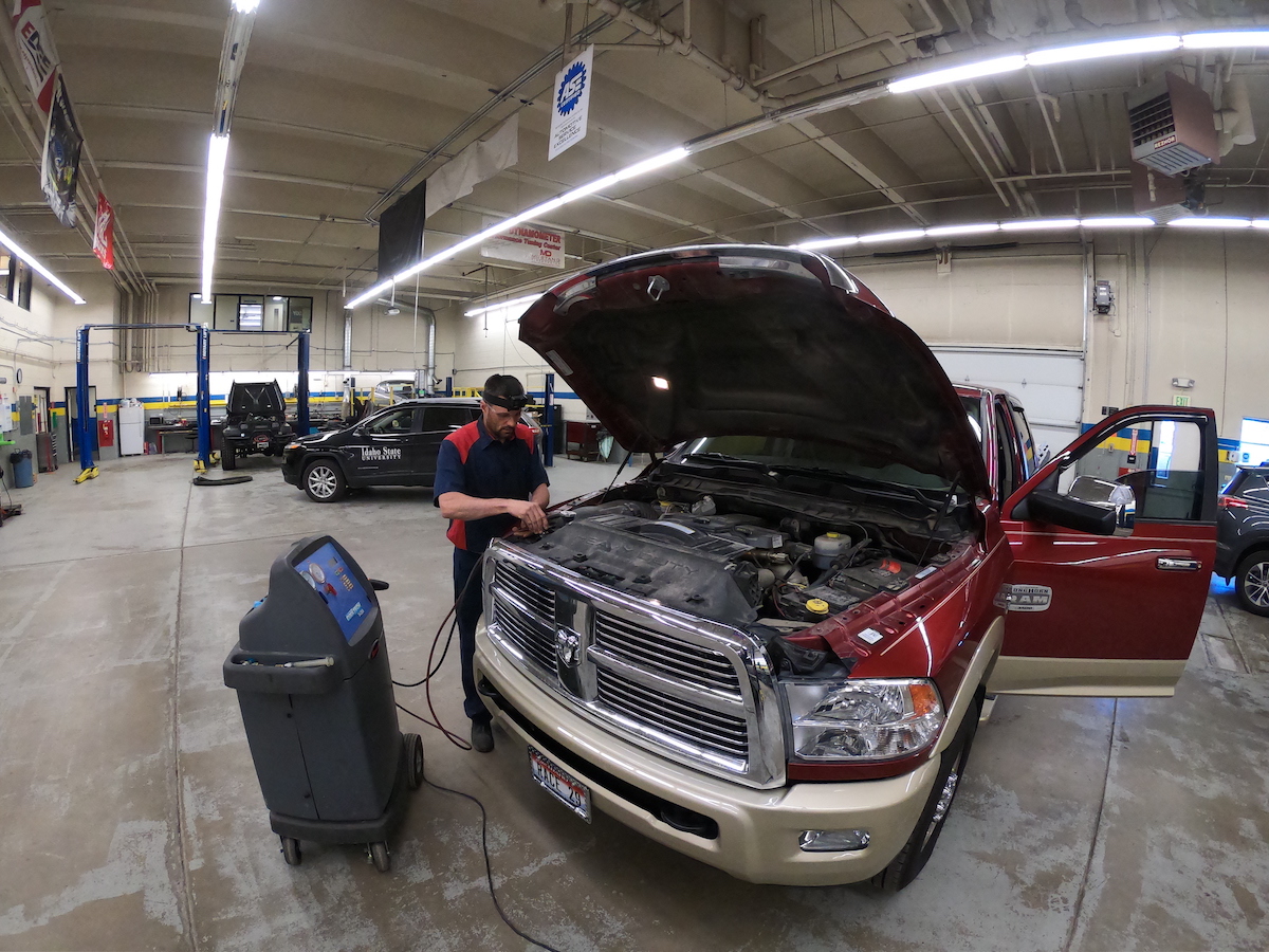 Brock Gunter working on a pickup engine in an empty shop. 