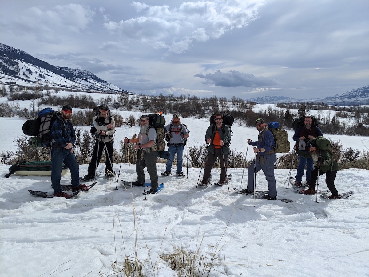 Group of snowshoers with beautiful scenery in background of mountains and snow,