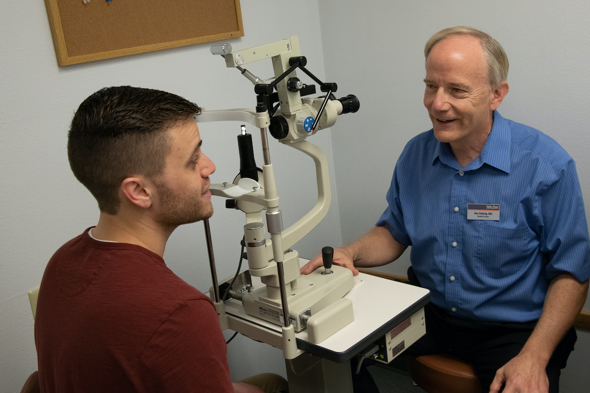 Ron Solbrig talking to a patient at the clinic.