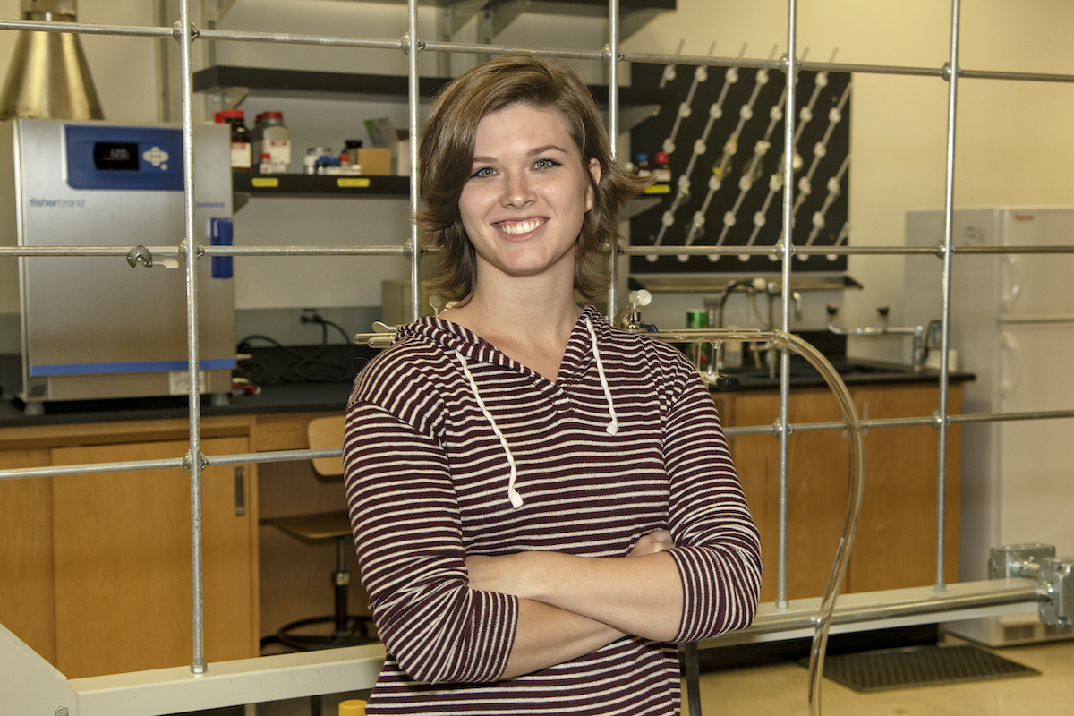 Kennalee Orme posing in chemistry lab.