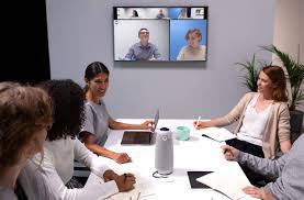 Meeting Owl setup on a table with screen in background