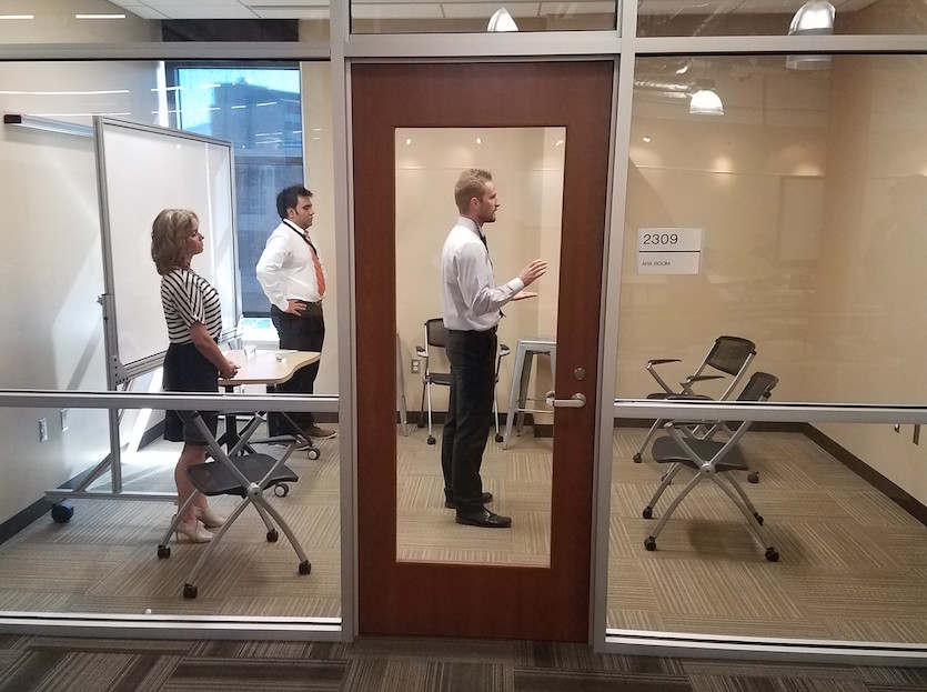 Photo of students in a room practicing for a pitch-off contest.