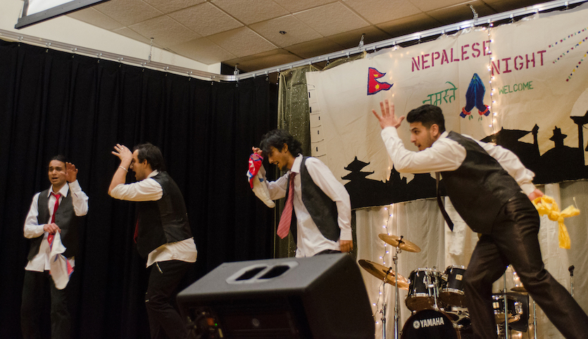 Scene from 2017 event featuring four male dancers on stage. 