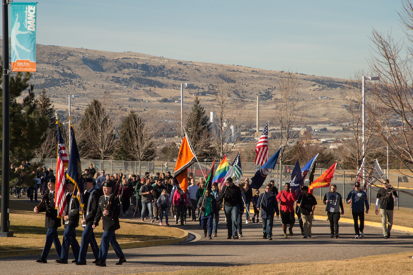 Photo of the head of the 2018 Martin Luther King March and marchers with a mountain in the background.