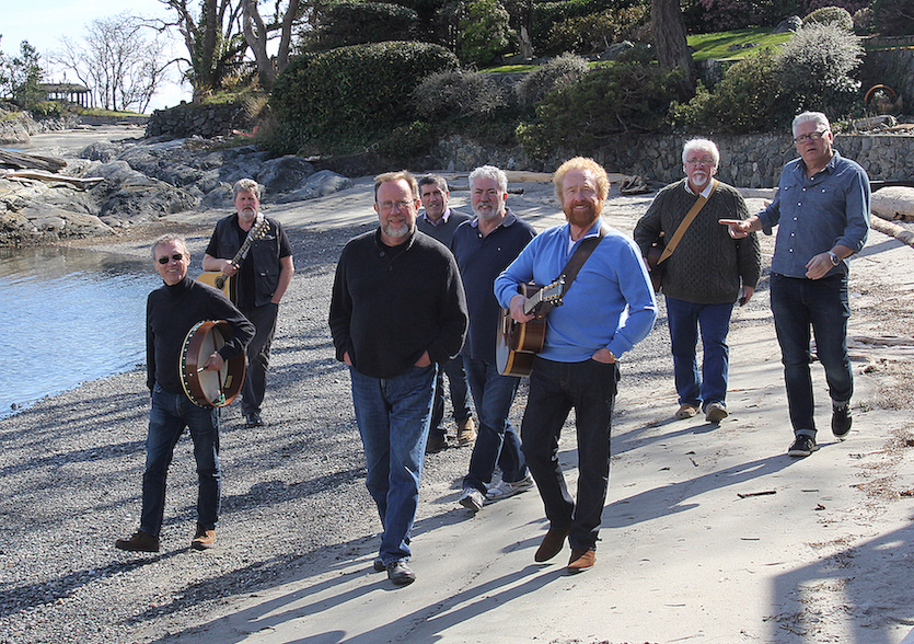 Photo of Irish Rovers walking on a beach.