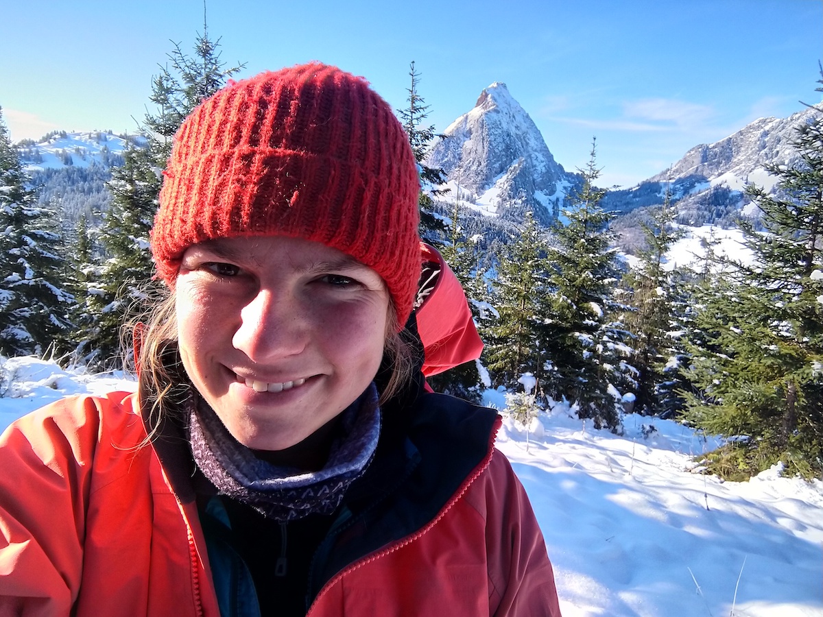 Student in foreground with alps in background.