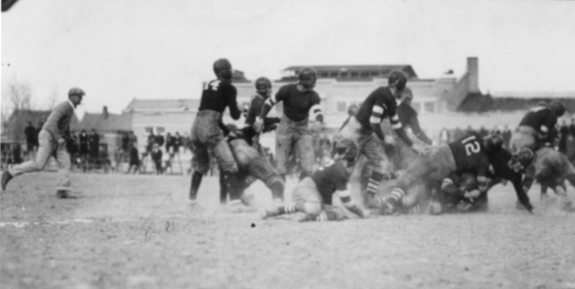 Historic photo of football players in the Spud Bowl. 