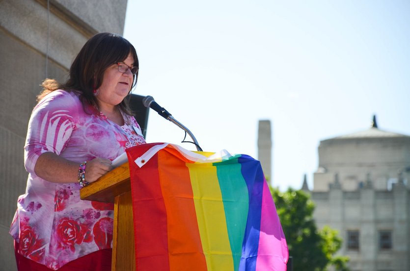 Dianne Piggott photo of her speaking at a podium.