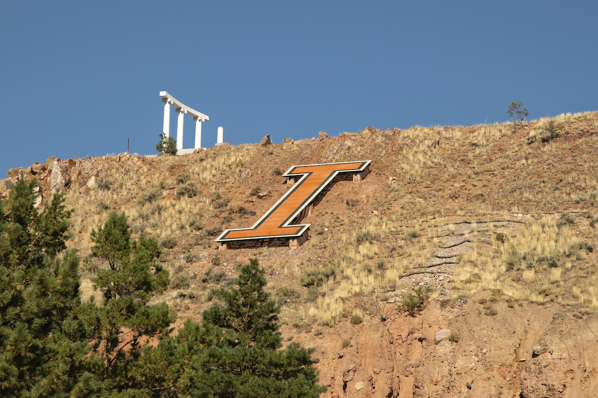 Red Hill I with pillars in background, trees in foreground.