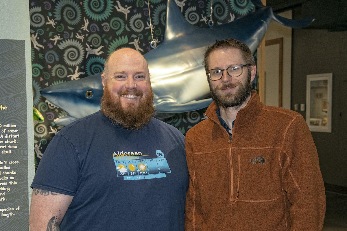 Jesse Pruitt and Leif Tapanila with a Edestus shark model hanging behind them