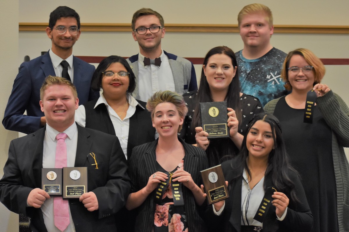 Debaters posing with awards.