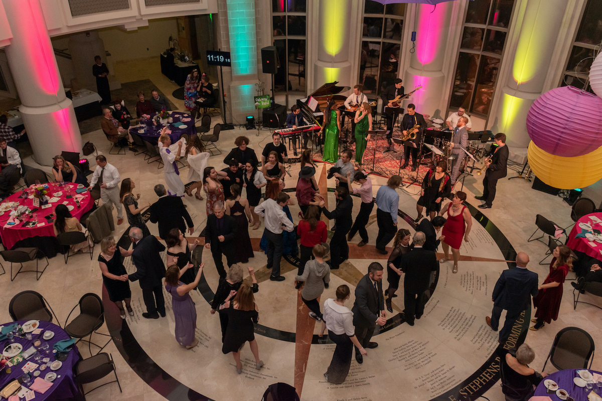  People dancing at a College of Arts and Letters New Year's Eve gala in the Stephens Center